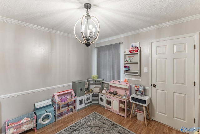 43 Terry Ln, Trinity, AL 35673 - game room featuring a chandelier, a textured ceiling, crown molding, and wood finished floors