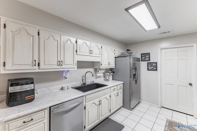 43 Terry Ln, Trinity, AL 35673 - kitchen with stainless steel appliances, a sink, light countertops, and light tile patterned floors