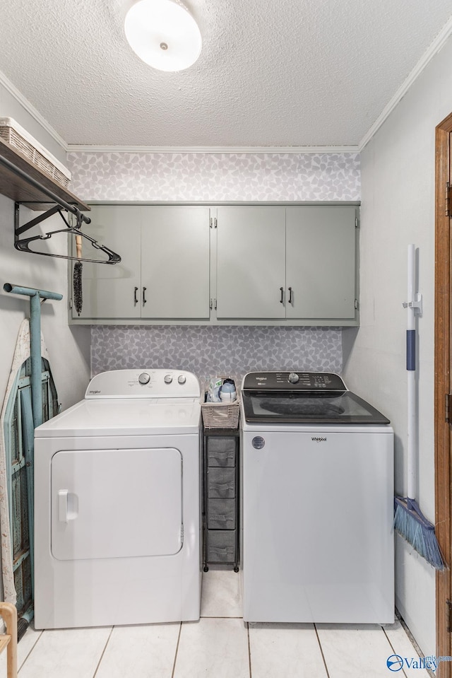43 Terry Ln, Trinity, AL 35673 - washroom with cabinet space, washing machine and clothes dryer, a textured ceiling, and crown molding