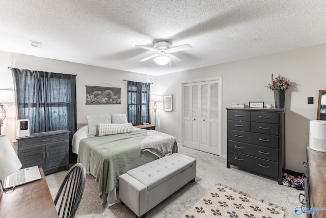 43 Terry Ln, Trinity, AL 35673 - bedroom with light colored carpet, a closet, a ceiling fan, and a textured ceiling