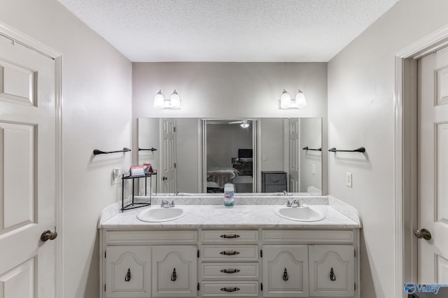 43 Terry Ln, Trinity, AL 35673 - full bathroom with connected bathroom, double vanity, and a textured ceiling
