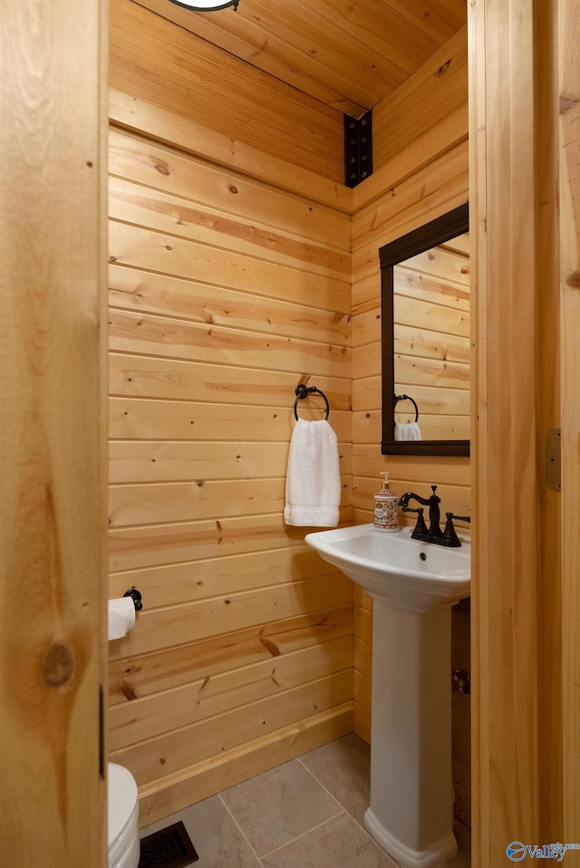 420 County Road 496, Centre, AL 35960 - bathroom with a sink, tile patterned floors, toilet, wood walls, and wood ceiling