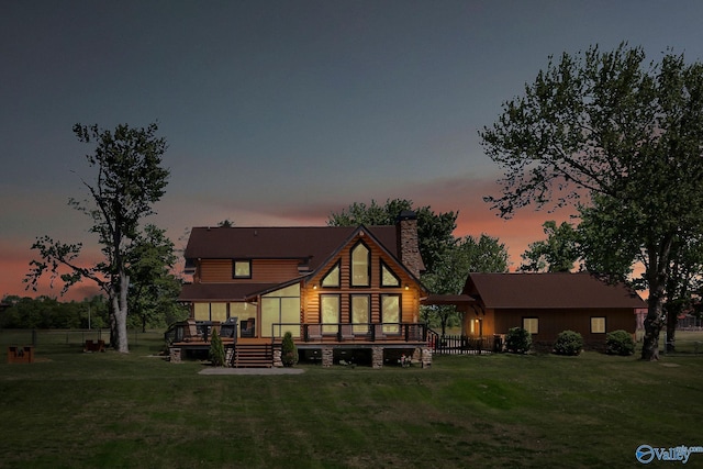 420 County Road 496, Centre, AL 35960 - back of house at dusk featuring a deck, a yard, and a chimney