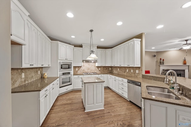 230 Knotting Pl, Madison, AL 35758 - kitchen with stainless steel appliances, dark stone countertops, white cabinets, light wood-type flooring, and recessed lighting