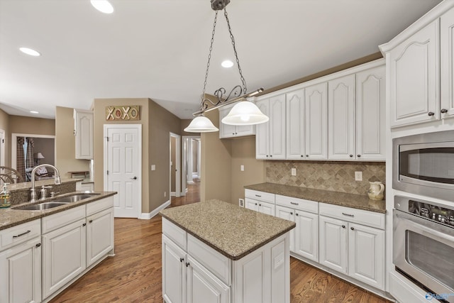 230 Knotting Pl, Madison, AL 35758 - kitchen featuring stainless steel appliances, backsplash, recessed lighting, a center island, and white cabinets