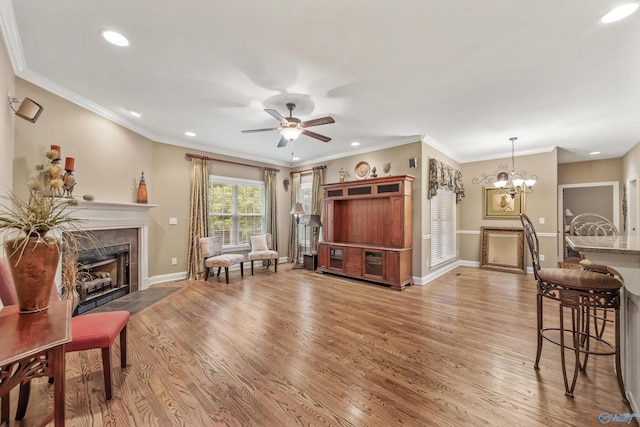 230 Knotting Pl, Madison, AL 35758 - living room with a premium fireplace, light wood finished floors, a ceiling fan, recessed lighting, and a chandelier