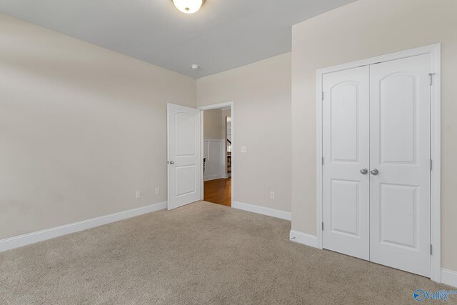 28622 Paseo Rd, Madison, AL 35756 - unfurnished bedroom with carpet floors, a closet, and baseboards