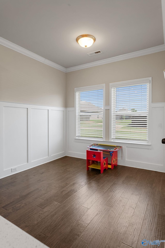 28622 Paseo Rd, Madison, AL 35756 - spare room featuring a decorative wall, wood finished floors, ornamental molding, and a wainscoted wall