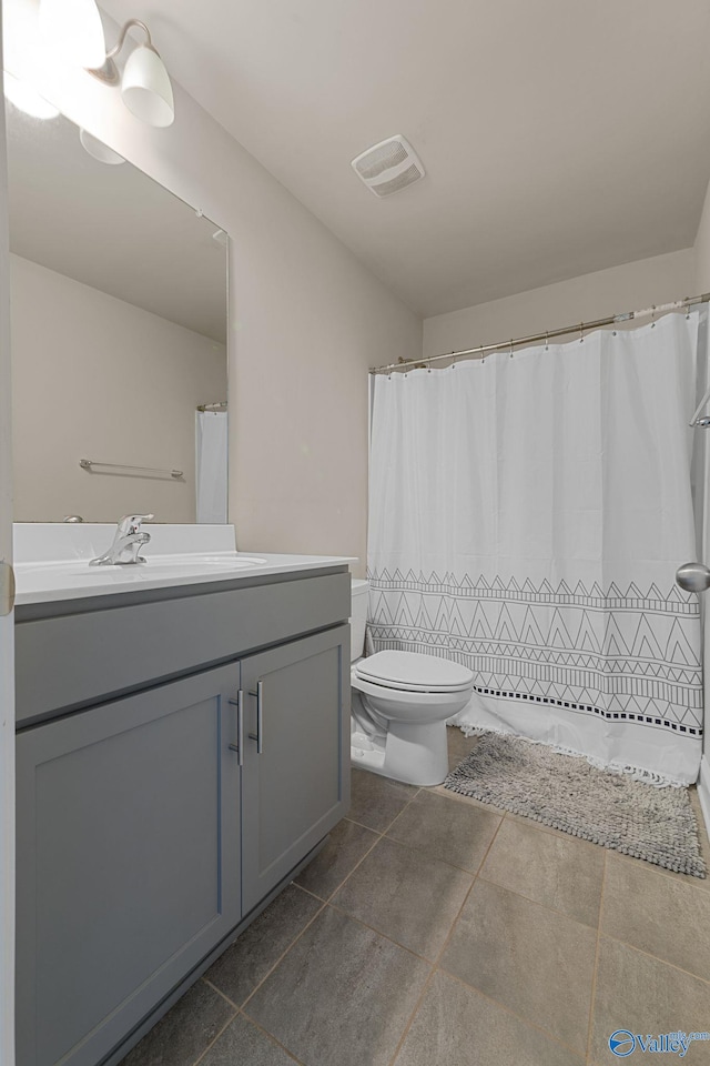 28622 Paseo Rd, Madison, AL 35756 - full bathroom with vanity, toilet, tile patterned floors, and a shower with shower curtain
