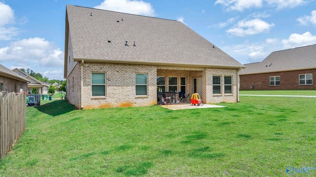 28622 Paseo Rd, Madison, AL 35756 - back of property with brick siding, a patio area, a lawn, and a shingled roof