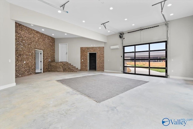 545 Pan Creek Rd, Baileyton, AL 35019 - unfurnished living room with concrete floors, recessed lighting, a garage, and brick wall