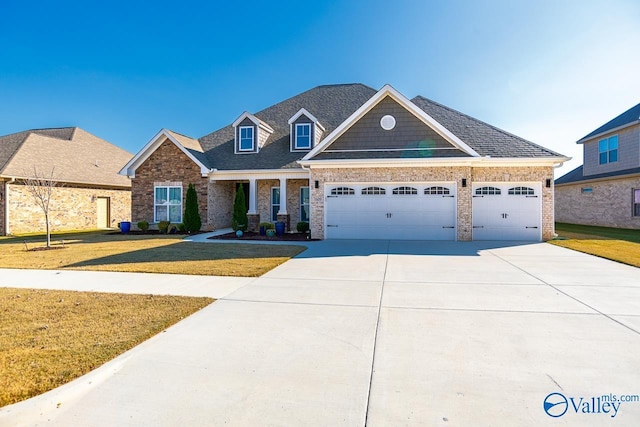 view of front of house featuring a garage and a front lawn