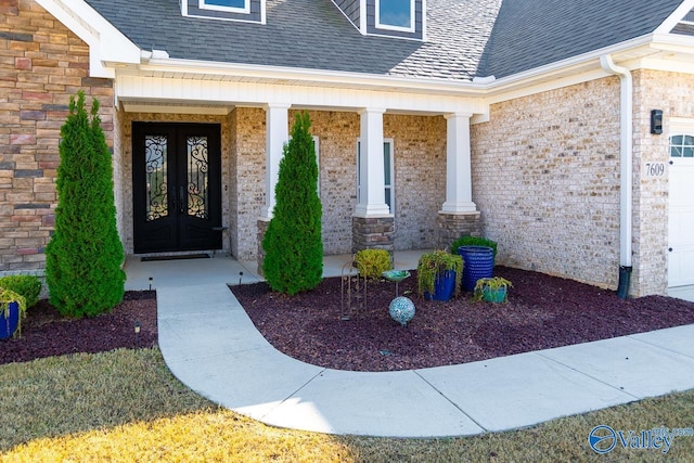 entrance to property featuring a porch and french doors