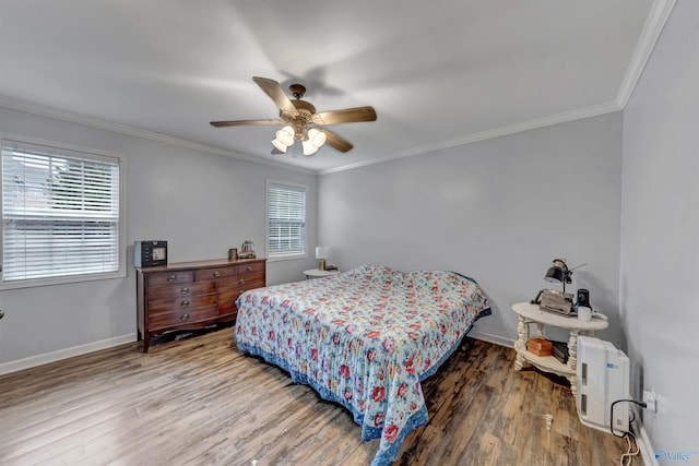 bedroom with hardwood / wood-style floors, ceiling fan, and ornamental molding