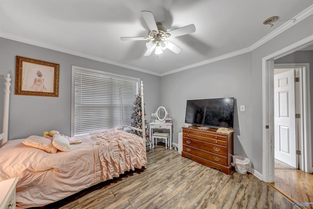 bedroom with ceiling fan, wood-type flooring, and crown molding