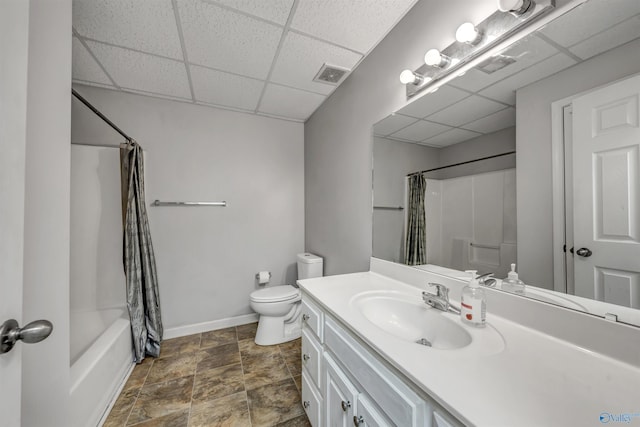 full bathroom featuring a paneled ceiling, vanity, shower / bath combo, and toilet