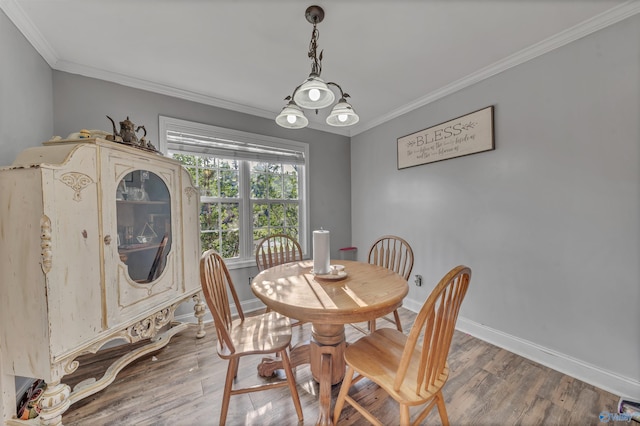 dining space featuring crown molding and hardwood / wood-style floors