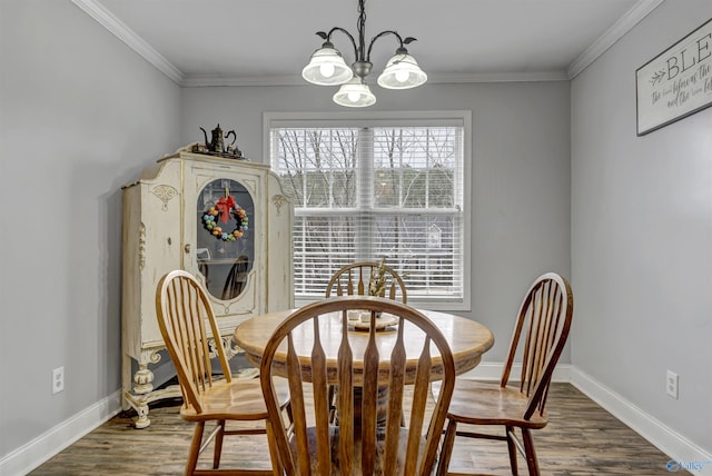 dining space with dark hardwood / wood-style flooring, a chandelier, and ornamental molding