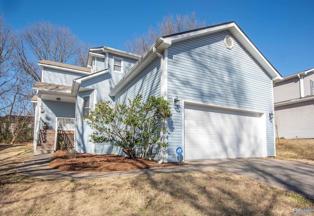 view of side of home featuring driveway and a garage