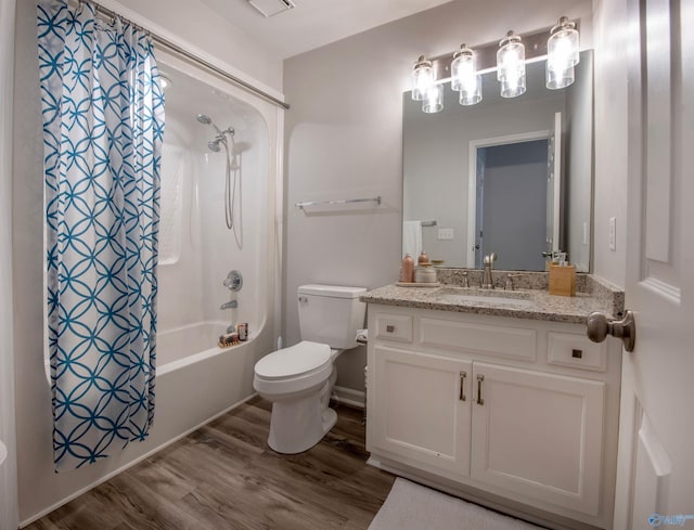 full bathroom featuring toilet, shower / bath combo, wood finished floors, and vanity