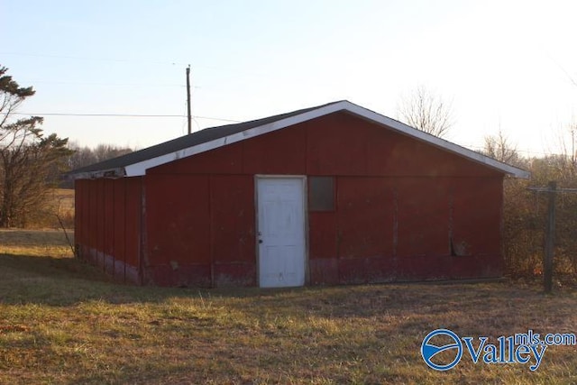 view of outbuilding with a yard