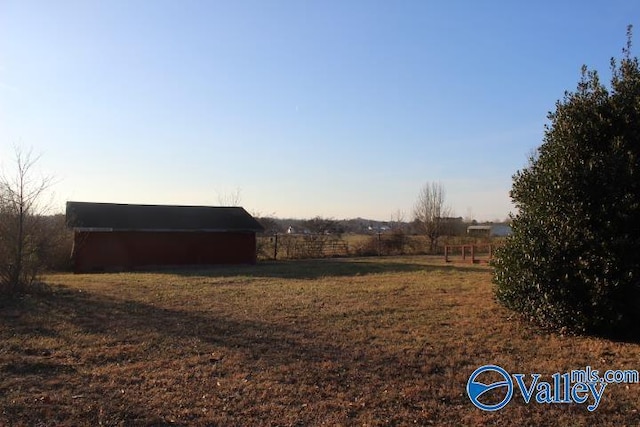 view of yard featuring an outbuilding and a rural view