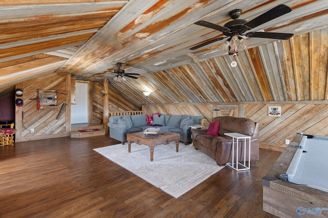 unfurnished living room with wood finished floors, wooden walls, a ceiling fan, and lofted ceiling