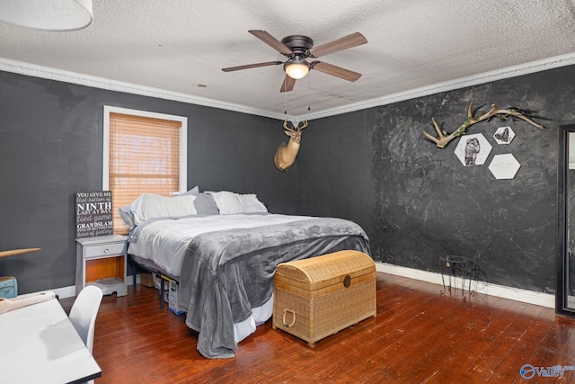 bedroom featuring hardwood / wood-style floors, ornamental molding, and a textured ceiling