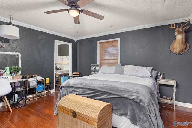 bedroom featuring ceiling fan, hardwood / wood-style flooring, ornamental molding, and a textured ceiling