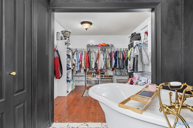 walk in closet featuring wood finished floors
