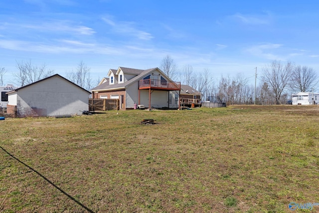 back of property featuring a yard and a wooden deck