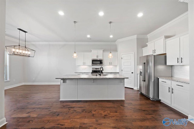 kitchen with a center island with sink, white cabinetry, hanging light fixtures, and appliances with stainless steel finishes