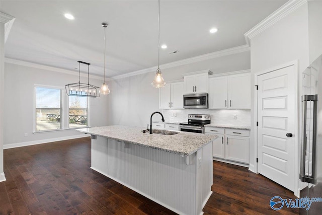 kitchen featuring white cabinetry, sink, pendant lighting, and appliances with stainless steel finishes