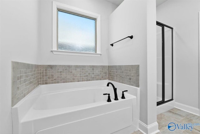 bathroom with separate shower and tub