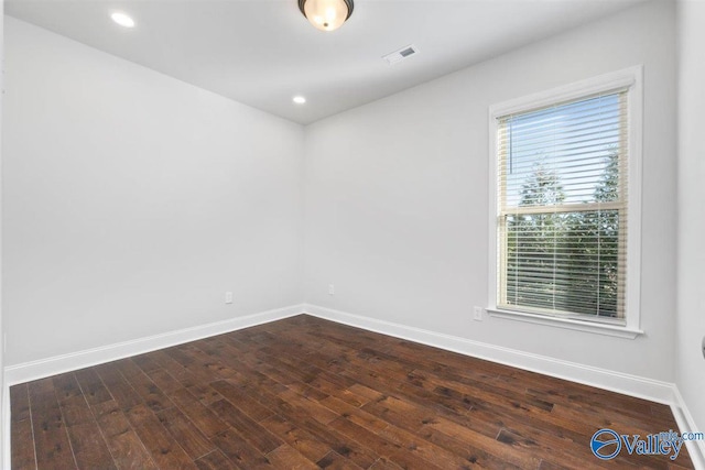 empty room with dark wood-type flooring