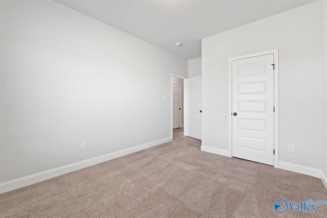 unfurnished bedroom with light colored carpet