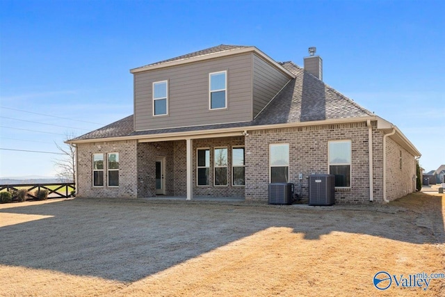 back of house featuring cooling unit