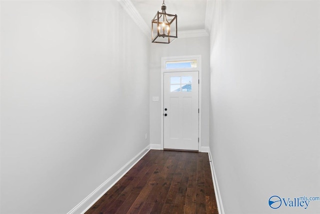 doorway to outside with dark wood-type flooring, a chandelier, and ornamental molding