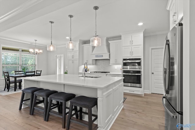 9045 Redstone Square Dr, Huntsville, AL 35824 - kitchen featuring stainless steel appliances, custom range hood, crown molding, a chandelier, and white cabinets