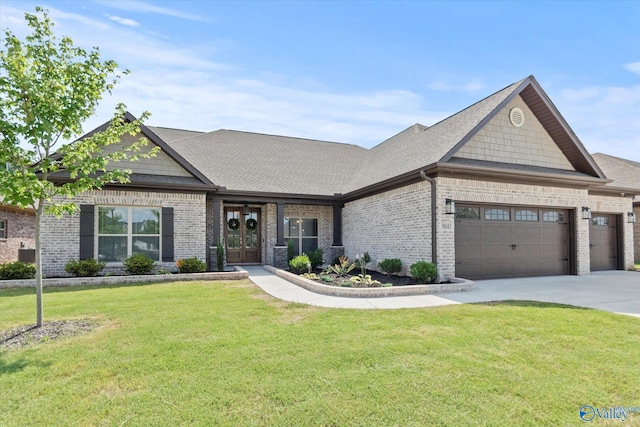 9045 Redstone Square Dr, Huntsville, AL 35824 - view of front facade with french doors, a garage, a front lawn, and brick siding