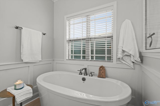 9045 Redstone Square Dr, Huntsville, AL 35824 - bathroom with a freestanding tub, a decorative wall, and a wainscoted wall