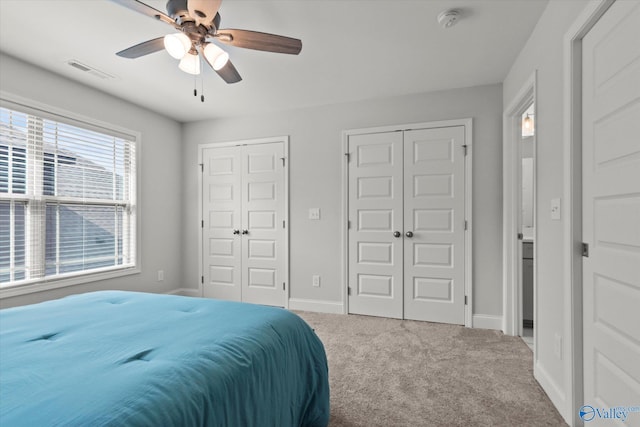 9045 Redstone Square Dr, Huntsville, AL 35824 - carpeted bedroom featuring multiple closets and ceiling fan