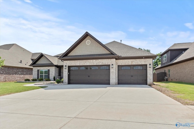 9045 Redstone Square Dr, Huntsville, AL 35824 - view of front of home featuring an attached garage, brick siding, driveway, a front lawn, and roof with shingles