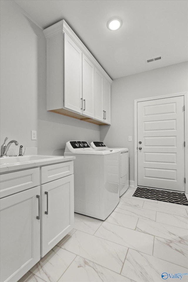 9045 Redstone Square Dr, Huntsville, AL 35824 - laundry room with washer and dryer, light marble finish floors, and cabinet space