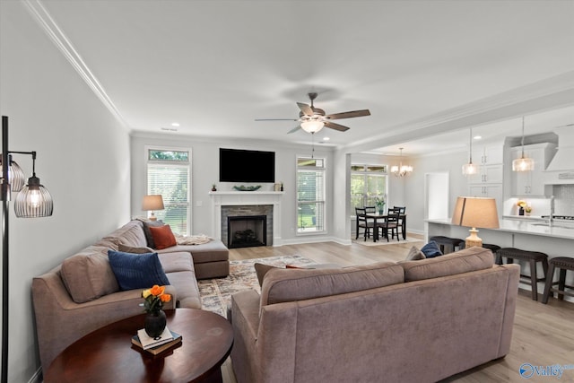 9045 Redstone Square Dr, Huntsville, AL 35824 - living area featuring plenty of natural light, crown molding, a ceiling fan, light wood finished floors, and a fireplace