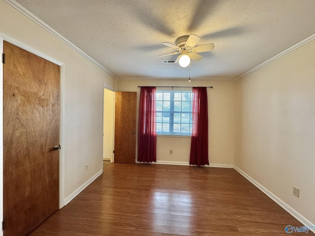 spare room with ceiling fan, ornamental molding, dark hardwood / wood-style floors, and a textured ceiling