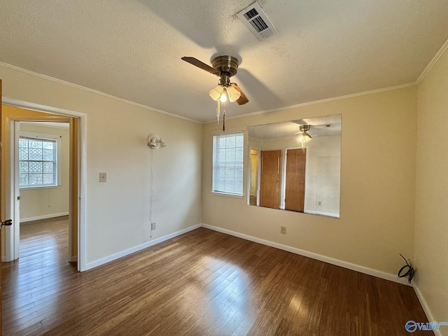 unfurnished room featuring hardwood / wood-style flooring, crown molding, a textured ceiling, and ceiling fan