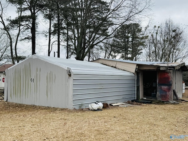 view of outbuilding featuring a lawn