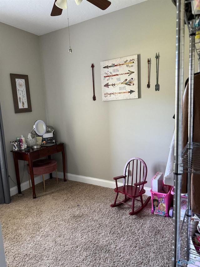 sitting room with baseboards, a ceiling fan, and carpet flooring