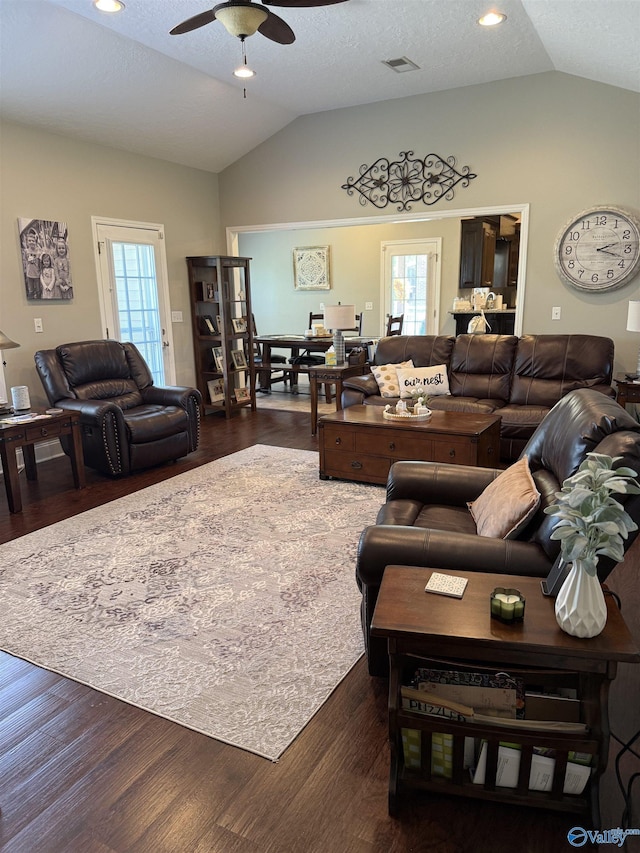 living area with dark wood-style flooring, vaulted ceiling, recessed lighting, visible vents, and ceiling fan